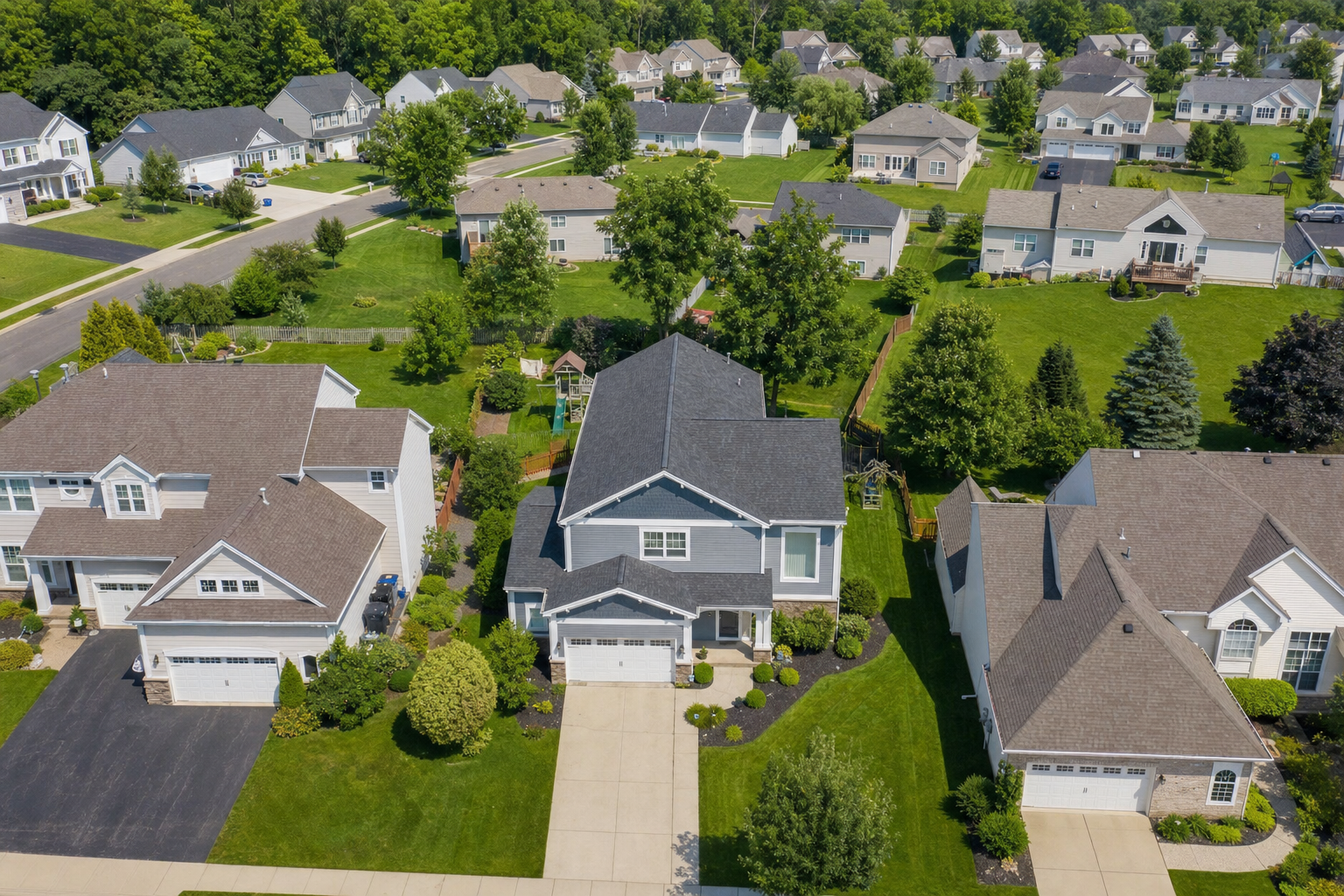 Aerial view of a suburban neighborhood with single-family investment properties